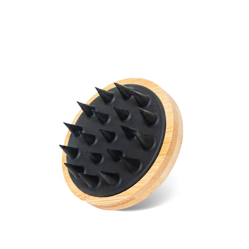ONNI Hair Growth Brush with silicone-free bristles and ergonomic bamboo handle for scalp massage.